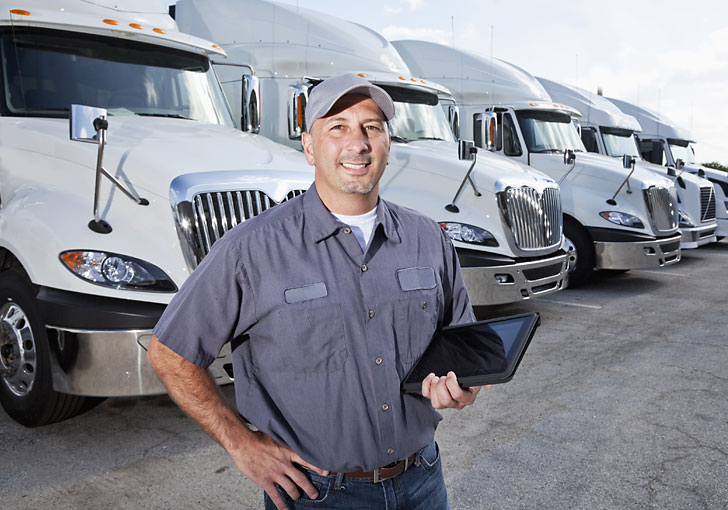 Truck driver holding laptop using business manager 365 Truck driver holding laptop using business manager 365